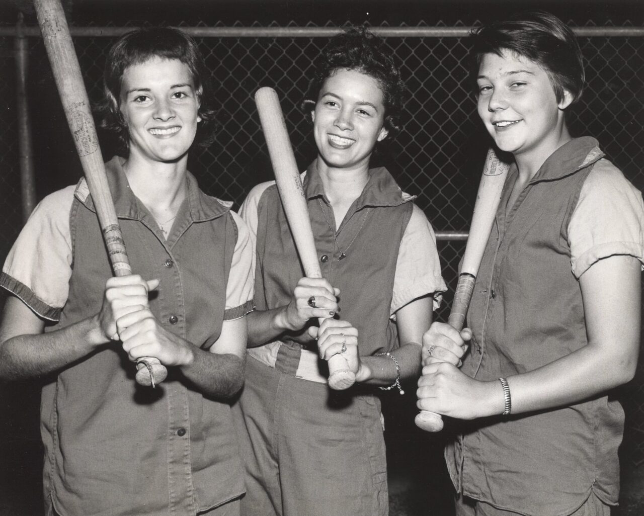 Click to expand image: baseball league members posing with baseball bats